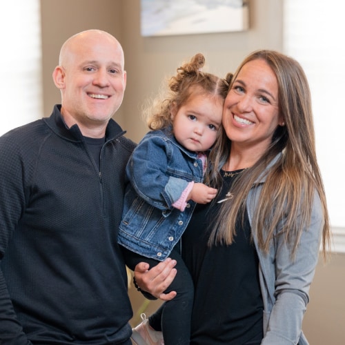 Parents holding a young girl